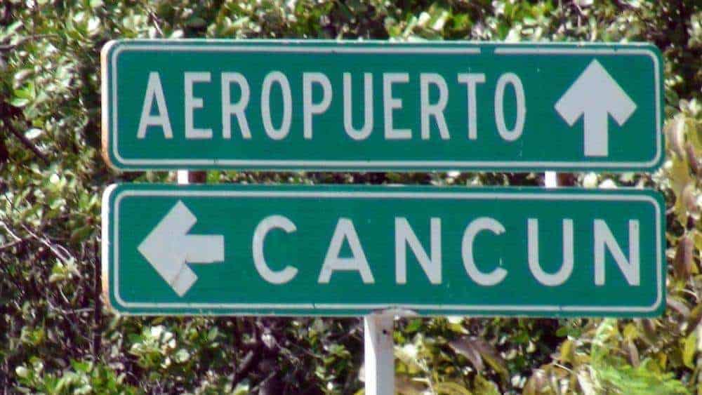 sign to airport and cancun